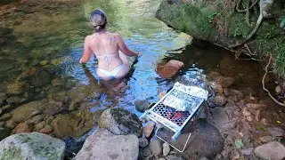 bathing in the river and preparing a delicious barbecue in nature - cooking outdoor