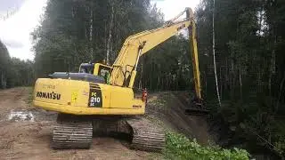 Cleaning the ditch bed with a long arm excavator