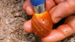 Red diamonds and agate emerge from crevices in rock after torrential rain