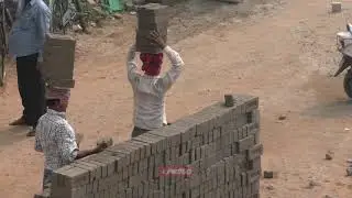 Indian construction workers use their heads
