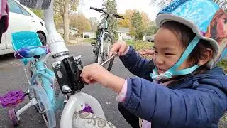 5 years old girl fixing her bike