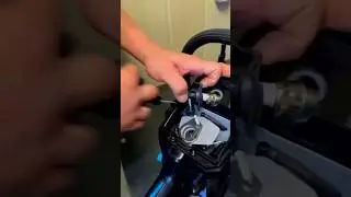 Checking the spark plug on a chainsaw.