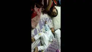 cute infant baby boy laughs adorable with big brother