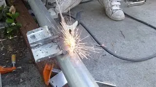 A beginner welds galvanized tubes into cantilever sliding gate frame, using BX1-200C1