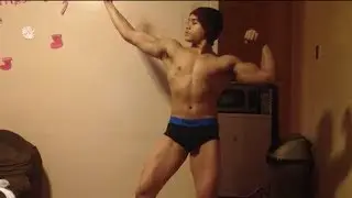 Teen bodybuilder flexing biceps