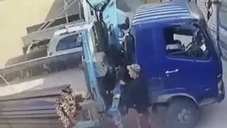 Idiot tries to stop truck from falling and nearly dies