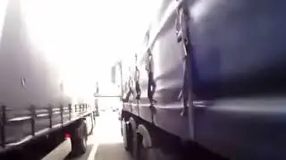 Rider Crashes Between Semis