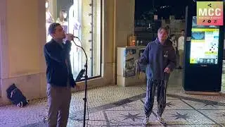 A passerby joins a street singer to sing 