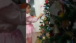 Karina decorates the Christmas tree