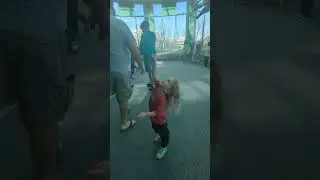 Big brother takes little brother to see the dinosaur exhibit