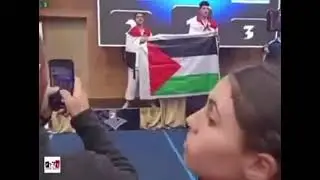 2 EGYPTIAN black belts raise the PALESTINIAN FLAG after defeating an ISRAELI