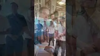 Seminarians singing a lullaby to a baby