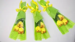 How to pack flowers. Bouquet of tulips with sweets. Needlework.