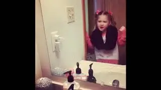 Pink pigtails girl sings in bathroom mirror