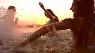 Group of happy teen girls playing in water at the beach.