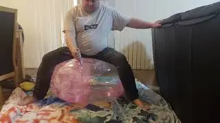 Popping 24 inch justice beach ball with knife while sitting on it