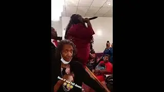 woman sings on church pew