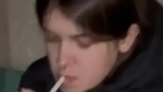 girl smokes a cigarette and talks to her friends about her experience of smoking and littering