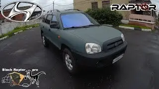 Hyundai Santa Fe painted in Raptor gray with black elements.