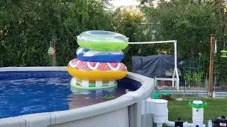 Noah in a 4 stacked floaty tower in his pool!