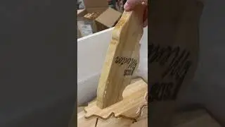The boards are pulled from the oil and placed in a tray to drip dry. 