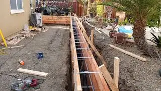 Veterans concrete,...formwork, rebar & footing progress @ high curb / fence line