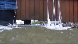 Feet and sneakers stuck in glue