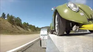 Trailer View of VW BUG driving through Colorado winding roads - time lapse