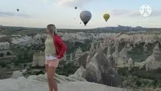 Balloons in the sky, and I'm posing;Cappadocia, Türkiye