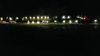Rail resurfacing train running at night.