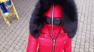 RED FITTING WOMEN'S SKI OVERALLS WITH BLACK FUR DEEP HOOD AND BELT.