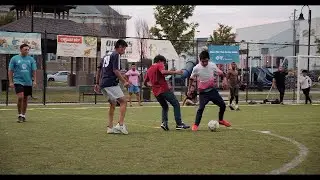 group of boys plays soccer in a soccer field