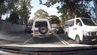 Blocks both lanes, then the left turn lane, and goes right