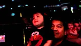 Zeia dancing in Daddy's lap at Sesame Street