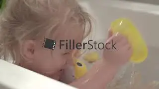 Little girl playing with toys in the bath