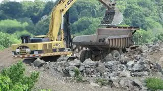 Komatsu PC600LC-7 Loading Caterpillar 769Cs with rock