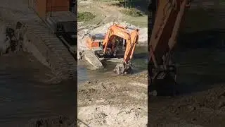excavator crossing river 