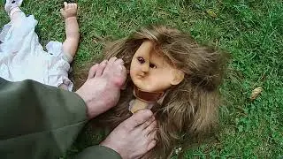 Bare feet trample , crush  doll...