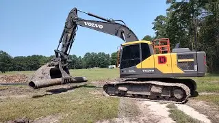 Piping The Pond Overflow Drain And Spreading Topsoil