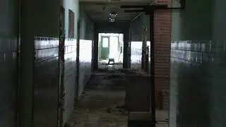 out of focus long shot slow zoom down dark hall