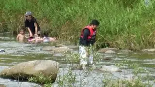 Adults Wading in Life Vests in Japan