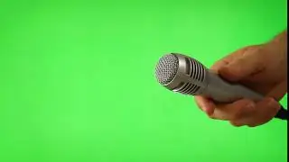 Holding Up The Mic Isolated On Green Screen