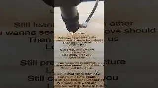 laser Engraving a poem onto a piece of wood.