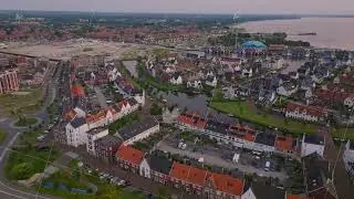Elevated view of a charming coastal town of Harderwijk with colorful homes, winding streets, and