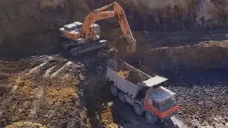 Hyundai Robex 480LC-9S loading Tatra 815 8x8 - Drone video