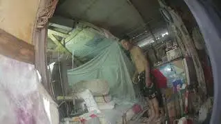 Khon Bia fixing his ceiling, THE PEOPLE WHO LIVE UNDER THE FREEWAY.