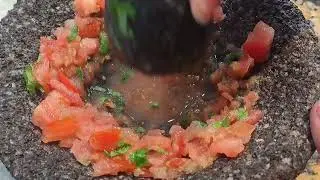 Making salsa in a molcajete