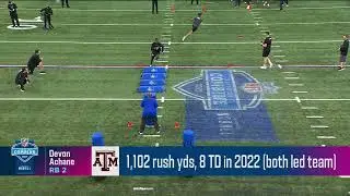 Aggies Devon Achane bulldozes a tackle dummy into the ground after a juke move