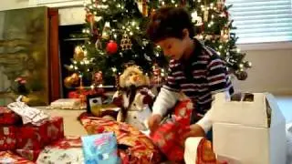 Daniel unwrapping his Christmas presents
