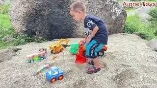 small kid play with his toys in beach